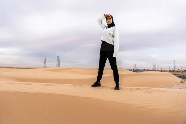 stock image Beautiful middle-eastern arab woman wearing hijab training outdoors in a desert area - Sportive athletic muslim adult female wearing burkini sportswear doing fitness workout