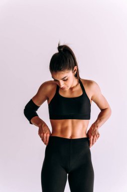 Spor aletlerini kullanarak spor salonunda antrenman yapan genç bir bayan sporcu. Formda kadın vücut çalışıyor. Zindelik, sağlık ve spor hazırlığı kavramları.