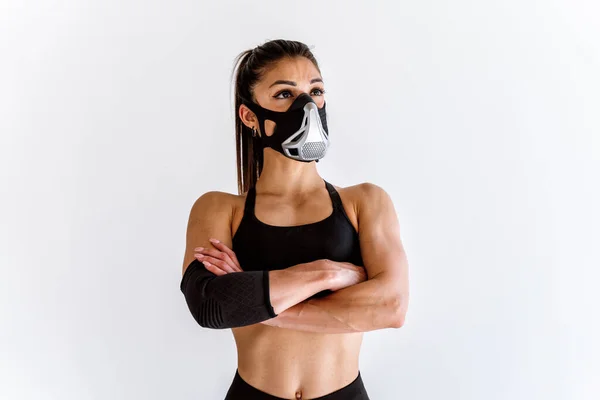 stock image Young female athlete training in a gym using sport equipment. Fit woman working out . Concept about fitness, wellness and sport preparation.