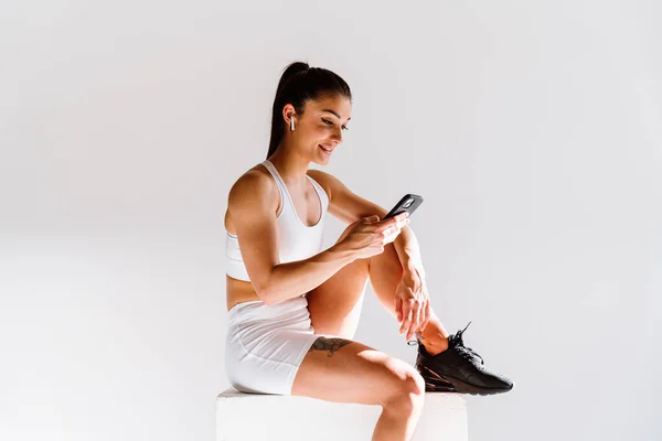 stock image Young female athlete training in a gym using sport equipment. Fit woman working out . Concept about fitness, wellness and sport preparation.