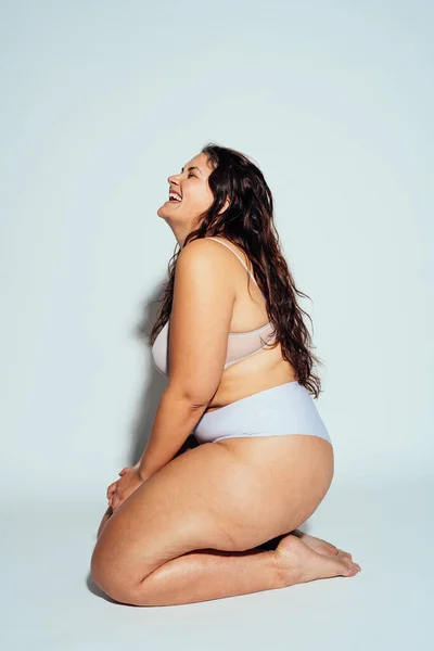stock image Plus size woman posing in studio in lingerie. Model on white background. Hard light studio shot