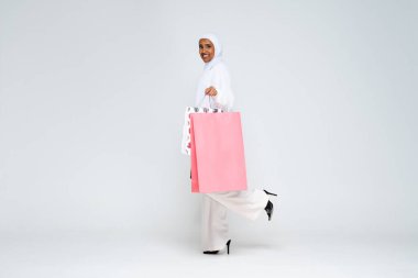 Stüdyoda geleneksel abaya elbisesiyle güzel bir Arap orta doğulu kadın siyah Afrikalı Müslüman yetişkin kadın Dubai, Birleşik Arap Emirlikleri 'nde şık ve şık bir elbise portresi giyiyor.