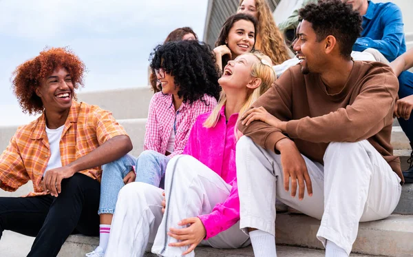 stock image Happy playful multiethnic group of young friends bonding outdoors - Multiracial millennials students meeting in the city, concepts of youth, people lifestyle, diversity, teenage and urban life