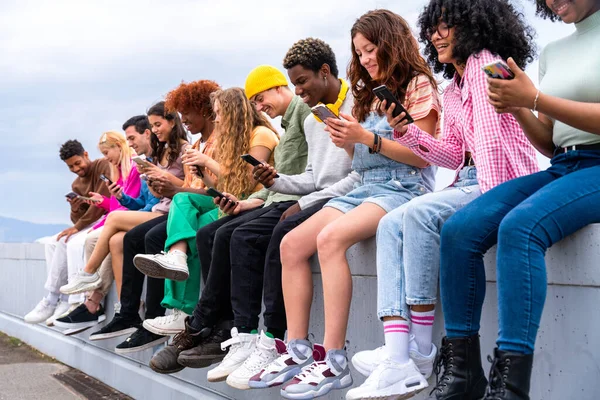 Stock image Happy playful multiethnic group of young friends bonding outdoors - Multiracial millennials students meeting in the city, concepts of youth, people lifestyle, diversity, teenage and urban life