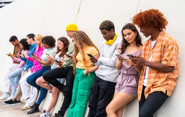 stock image Happy playful multiethnic group of young friends bonding outdoors - Multiracial millennials students meeting in the city, concepts of youth, people lifestyle, diversity, teenage and urban life