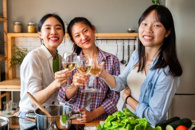 Mutlu Çinli kadın arkadaşlar evde kaynaşıyor ve birlikte lezzetli yemekler pişiriyorlar eğlenceli Asyalı kadın yetişkinler buluşuyor ve evde eğleniyorlar, yaşam tarzı, ev hayatı ve arkadaşlık kavramları.