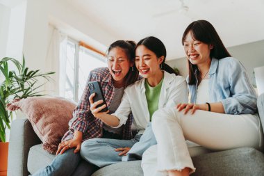 Mutlu güzel Çinli kadın arkadaşlar evde kaynaşıyor, eğlenceli Asyalı kadın yetişkinler buluşuyor ve evde eğleniyorlar, yaşam tarzı, aile hayatı ve arkadaşlık kavramları