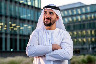 Arap Ortadoğu 'lu, Emirati Kandora giysili, şehirde geleneksel giysiler giyen Arap Müslüman iş adamı, şehir iş merkezinde geziniyor..