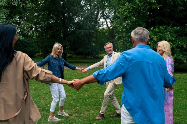 Group of old friends spending time together in the main parts of london, visiting the westminster area and st. james park. Old buddies reunion. Concept about third age and seniority