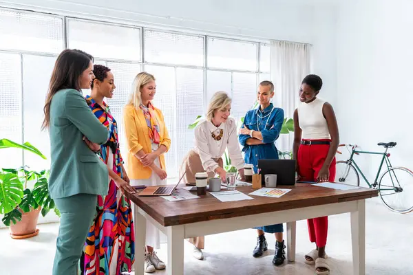 Group of beautiful confident businesswomen meeting in the office - Multiethinc female creative team brainstorming at work - Diverse colleagues working together  in workshop  in a co-working space