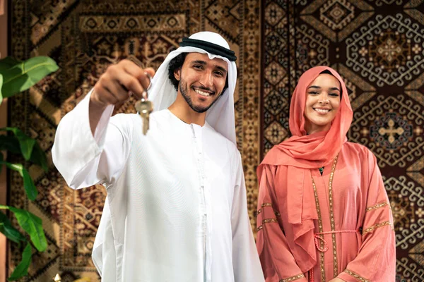 Emirati 'li genç bir çift geleneksel Arap kafesinde vakit geçiriyor. Kandura giyen kadın ve erkek Dubai 'den abaya sohbet ediyorlar..