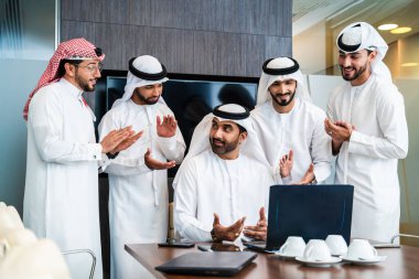 Bir grup Arap işadamı ofiste buluşuyor - Ortadoğulu iş adamları emirati kandora giyiyorlar, Dubai 'de bir toplantı odasında çalışıyorlar.