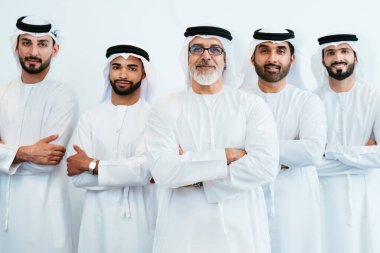 Bir grup Arap işadamı ofiste buluşuyor - Ortadoğulu iş adamları emirati kandora giyiyorlar, Dubai 'de bir toplantı odasında çalışıyorlar.