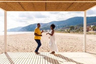 Güzel, olgun, siyahi çift deniz kenarında flört ediyor evli, orta yaşlı çift dışarıda eğleniyor, ilişki, yaşam tarzı ve yaşam kalitesi kavramları.