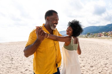Güzel, olgun, siyahi çift deniz kenarında flört ediyor evli, orta yaşlı çift dışarıda eğleniyor, ilişki, yaşam tarzı ve yaşam kalitesi kavramları.