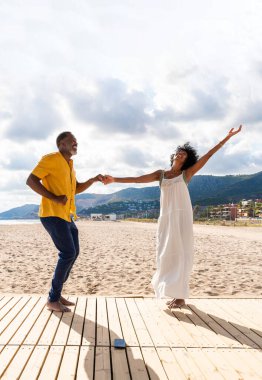 Güzel, olgun, siyahi çift deniz kenarında flört ediyor evli, orta yaşlı çift dışarıda eğleniyor, ilişki, yaşam tarzı ve yaşam kalitesi kavramları.