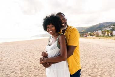 Güzel, olgun, siyahi çift deniz kenarında flört ediyor evli, orta yaşlı çift dışarıda eğleniyor, ilişki, yaşam tarzı ve yaşam kalitesi kavramları.