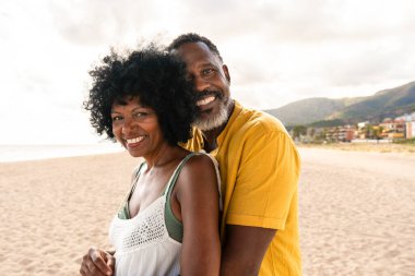 Güzel, olgun, siyahi çift deniz kenarında flört ediyor evli, orta yaşlı çift dışarıda eğleniyor, ilişki, yaşam tarzı ve yaşam kalitesi kavramları.