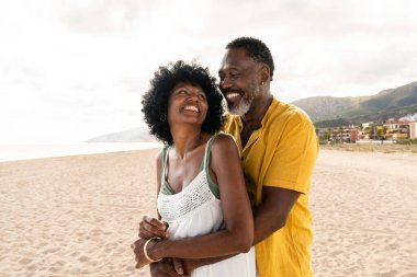 Güzel, olgun, siyahi çift deniz kenarında flört ediyor evli, orta yaşlı çift dışarıda eğleniyor, ilişki, yaşam tarzı ve yaşam kalitesi kavramları.