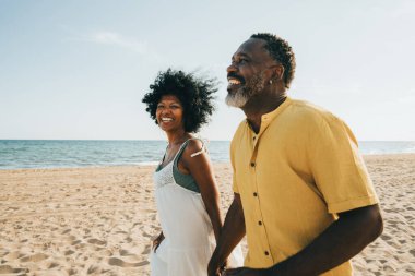 Güzel, olgun, siyahi çift deniz kenarında flört ediyor evli, orta yaşlı çift dışarıda eğleniyor, ilişki, yaşam tarzı ve yaşam kalitesi kavramları.