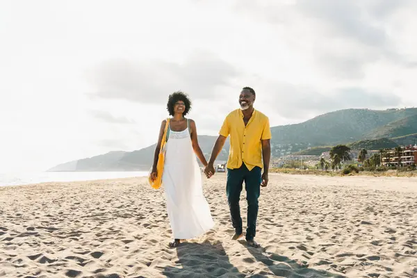 Güzel, olgun, siyahi çift deniz kenarında flört ediyor evli, orta yaşlı çift dışarıda eğleniyor, ilişki, yaşam tarzı ve yaşam kalitesi kavramları.