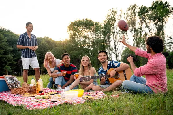 多民族のティーンエイジャーのグループは 公園でピクニックに屋外で時間を費やしています Z世代 ライフスタイル 友情についてのコンセプト — ストック写真