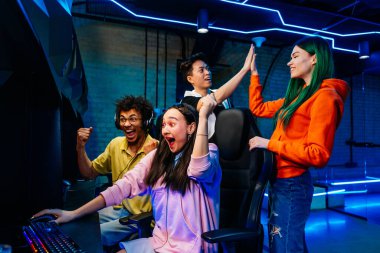 Video oyunları oynayan çok ırklı bir grup genç arkadaş - Sanal oyunlar turnuvasında rekabetçi video oyunlarında oynayan profesyonel esport oyuncuları takımı
