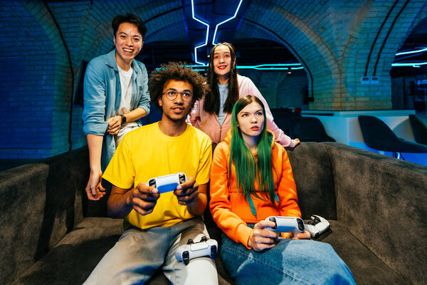 Multiethnic Group Young Friends Playing Videogames Home Sitting Sofa Videogamers Stock Picture