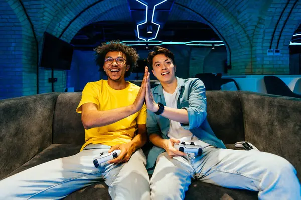 Multiethnic Group Young Friends Playing Videogames Home Sitting Sofa Videogamers Stock Picture