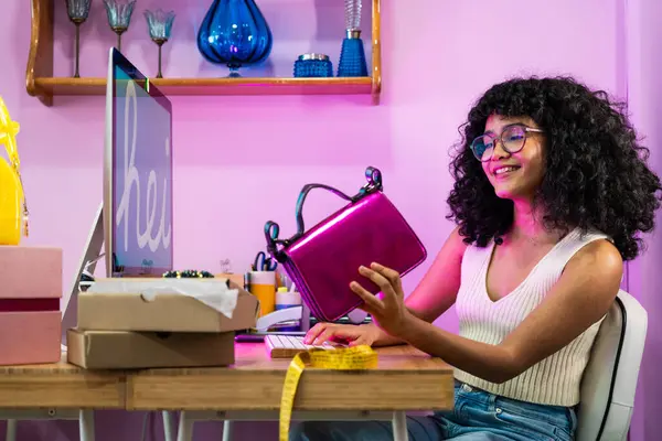 stock image Beautiful young hispanic woman managing her home clothing e-commerce business from home - Female designer  owns online shopping store, concepts of home business and reselling second hand accessories