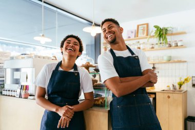 Bakery, happy portrait of hispanic black man and woman in cafe ready for serving pastry, coffee and baked foods - Confident waiter barista by counter for service, help and welcome in a coffee shop