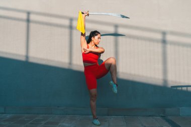 Çinli genç bir kadın dışarıda Wushu kung fu 'su yapıyor. Dövüş sanatları eğitimi alan genç bir kız..