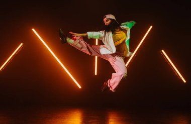 Neon ışıkları olan havalı bir stüdyoda hip hop dansçısı..
