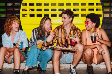 Arkadaşların akşam dışarı çıkıp parti yapıyor. Gençler hafta sonları dışarıda buluşup renkli kokteyller ve pizzayla kutlama yapıyorlar. Ön flaş fotoğraf biçimi.