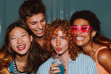 Arkadaşların akşam dışarı çıkıp parti yapıyor. Gençler hafta sonları dışarıda buluşup renkli kokteyllerle kutlama yapıyorlar. Ön flaş fotoğraf biçimi.