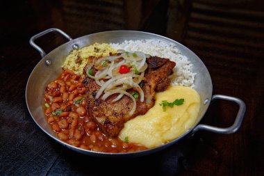 fasulye, pilav, patates püresi, kızarmış et ve soğan dilimleri. 