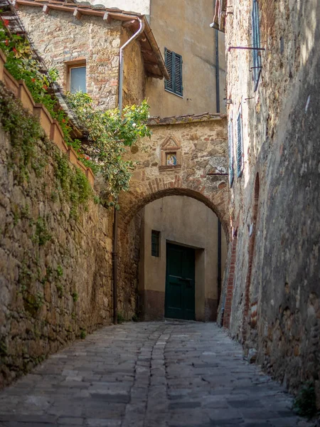The colorful medieval houses and alleys of San Quirico d\'Orcia in a sunny spring day