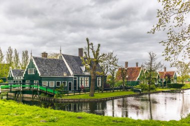 Old houses, wooden boats and farms in the picturesque village of Zaanse Schans in the Netherlands clipart