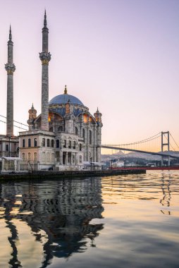 Sabahın erken saatlerinde İstanbul 'daki Ortakoy Camii' nin arka planda hareket eden bir konteynır gemisiyle uzun süre açıkta kalması