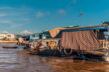 Vendors and their boats at the floating market of Cai Reng in Vietnam early in the morning clipart