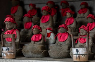 Little stone staues representing Jizo Bodhisattva, the guardian deity for children at the Kiyomizu temple in Kyoto clipart