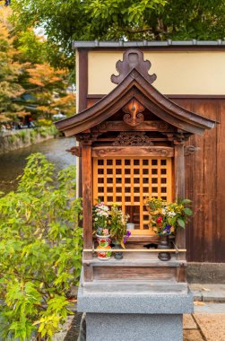 Wooden old houses and colorful trees in autumn along the Shirakawa canal in Kyoto clipart