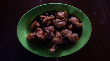 Teriyaki usulü tavuk filetosu yeşil tabak Asya mutfağında servis edildi.