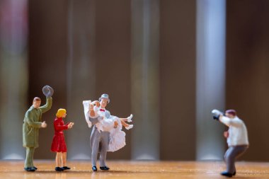 Miniature people, Photographer taking pictures of a bride and groom, Valentine day concept