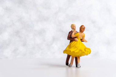 Miniature people Couple dancing on dance floor , International dance day concept