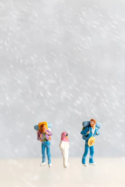 Miniature people Happy family Travel in winter time , Winter Travel concept