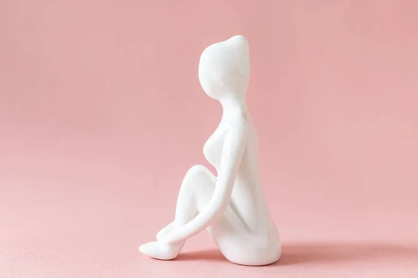 stock image Ceramic Yoga Figurine of Woman doing yoga pose on pink background