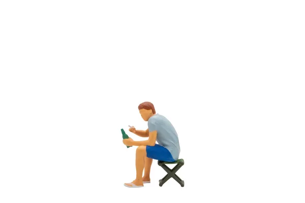 Pessoas Miniatura Jovem Sentado Uma Cadeira Gramado Isolado Fundo Branco — Fotografia de Stock