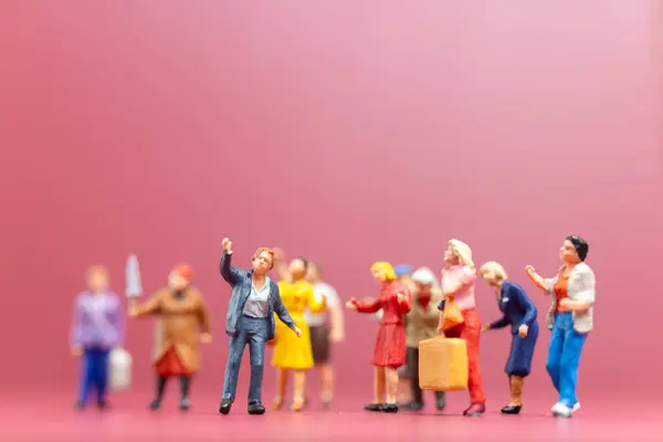 Miniature people , A group of women stand together On a pink backdrop, International Women\'s Day concept