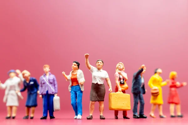 Miniature people , A group of women stand together On a pink backdrop, International Women\'s Day concept